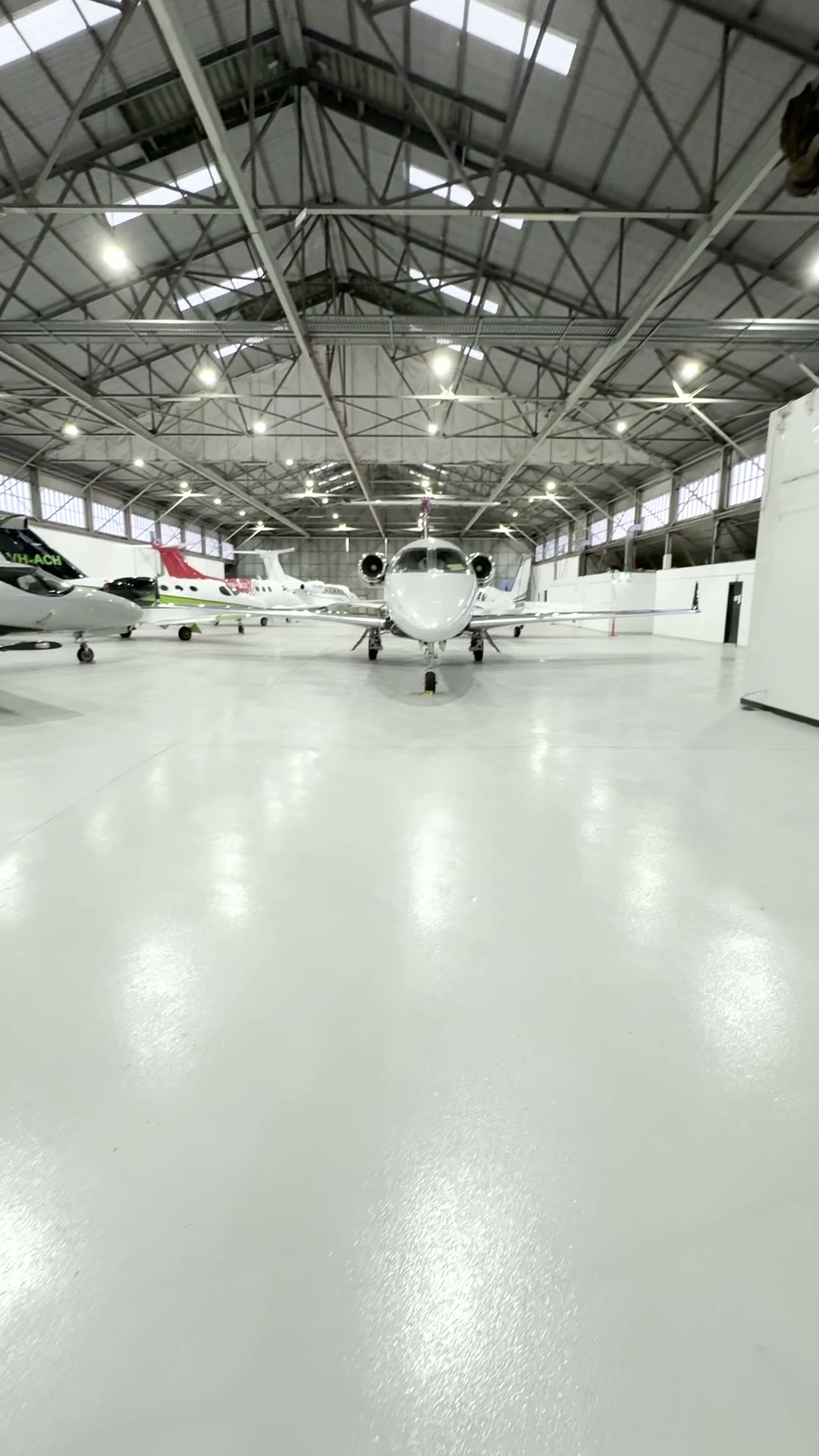 Finished aircraft hangar concrete floor with aircraft visible